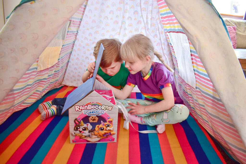 Twins looking at Puppycorns package