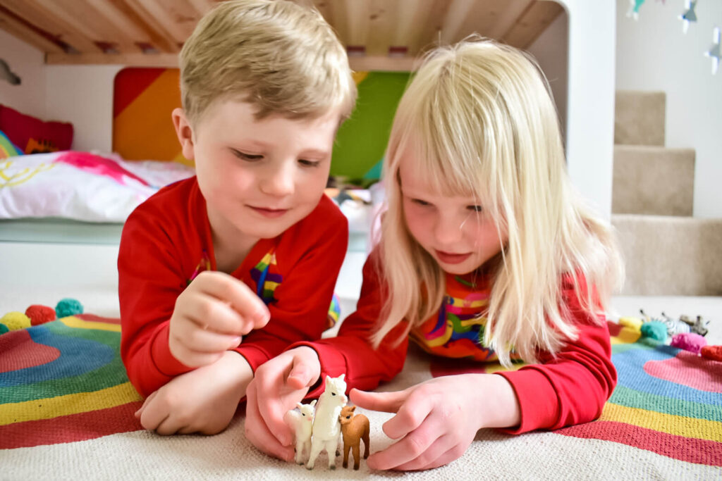 Twins playing with Schleich Wild Life toys