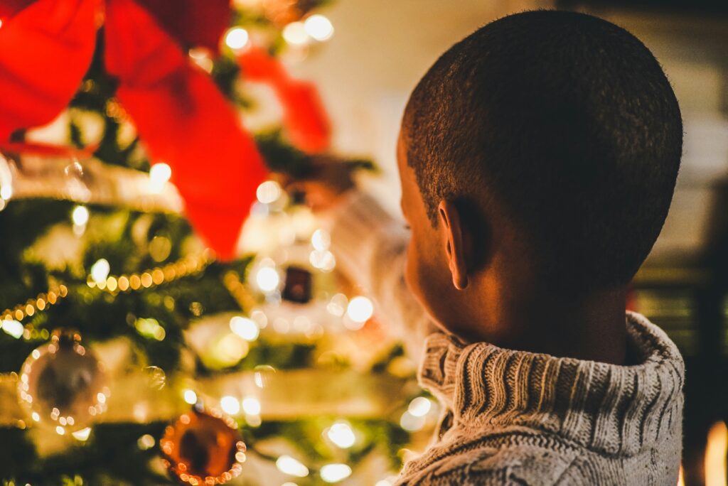 child looking at Christmas tree
