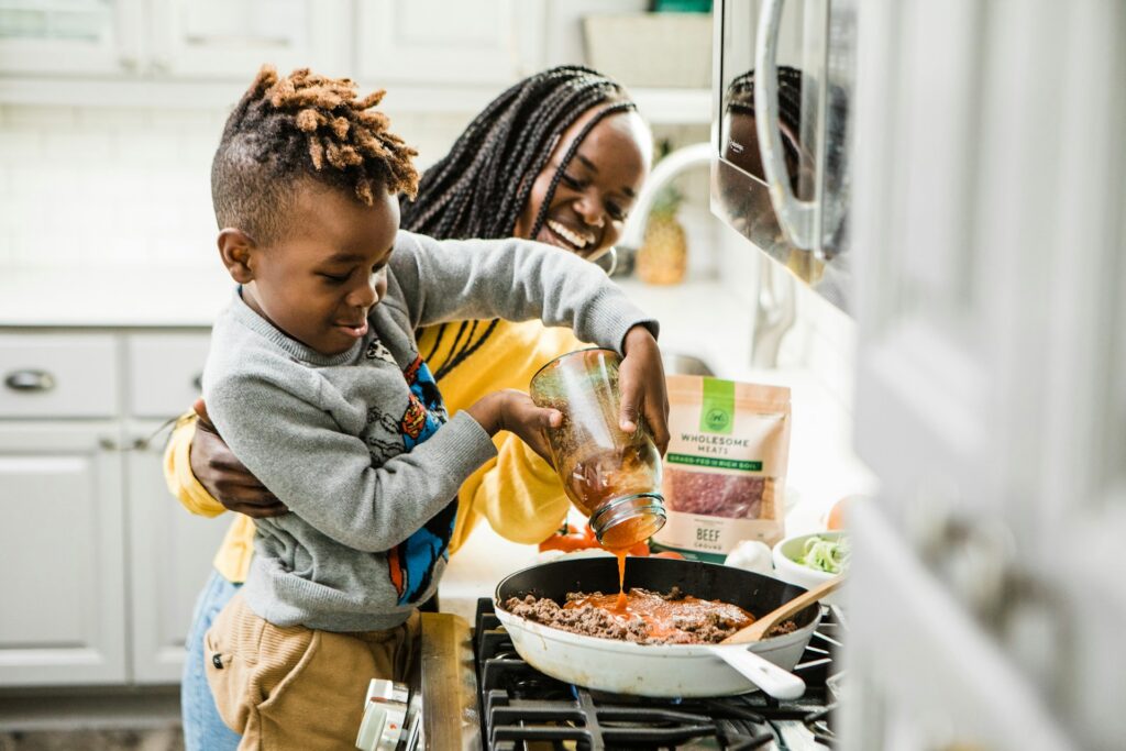 mother and child cooking together in kitchen