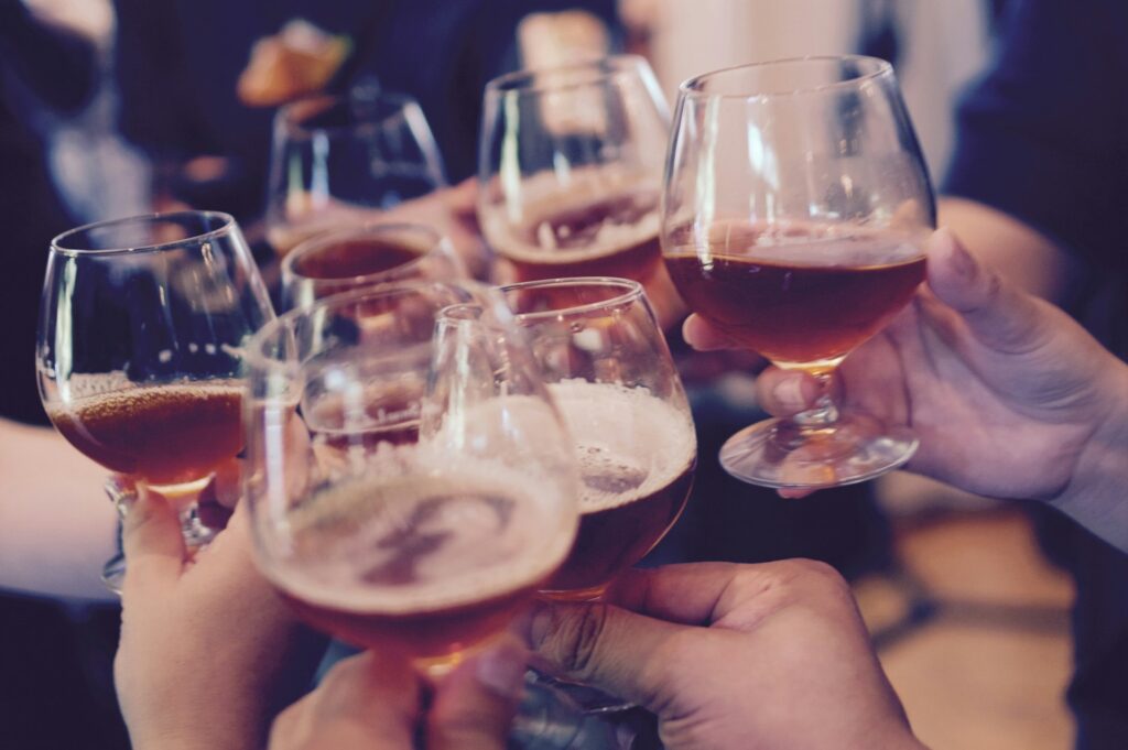hands holding drinks at a party