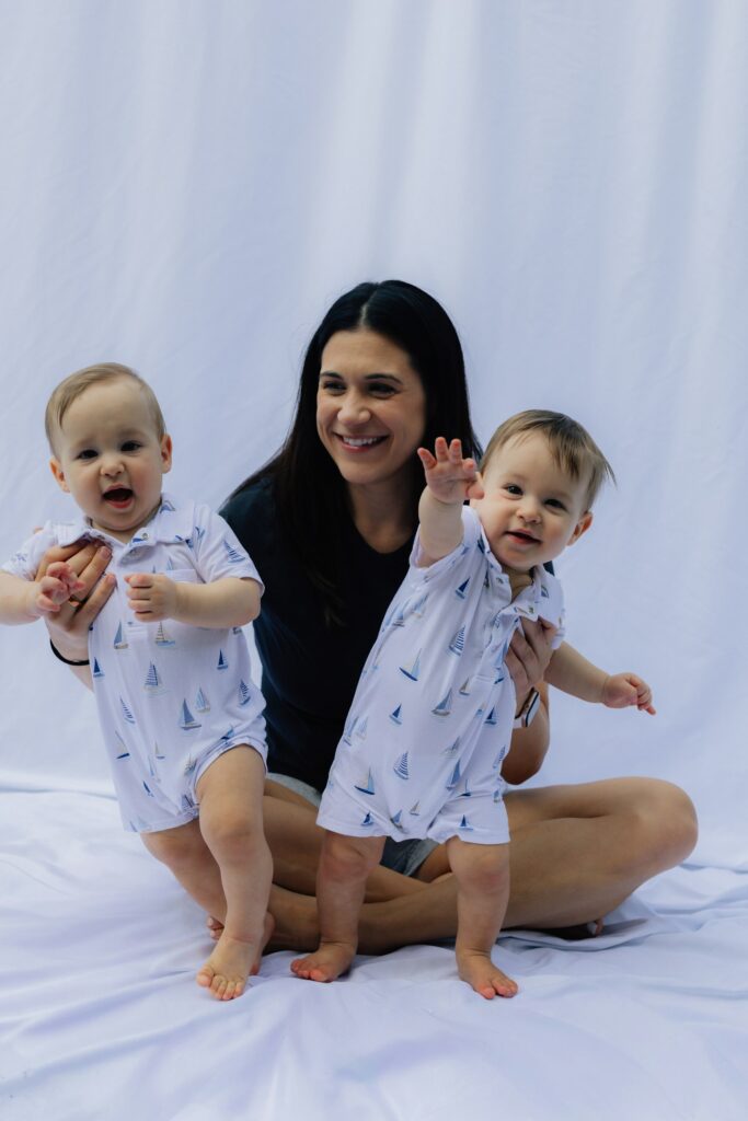 smiling mother with identical baby twins